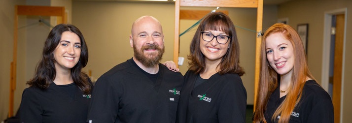 Chiropractor Burlington MA Andy Mutter and Kandyce Mutter With Staff